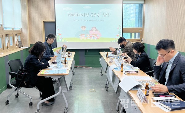 2023년 평택시 아빠육아 사진 공모전에 응모한 작품들을 심사위원들이 심사하고 있다.